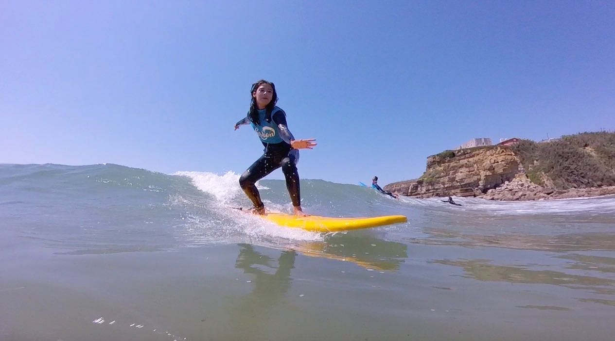 Surfer riding a wave at Magoito beach