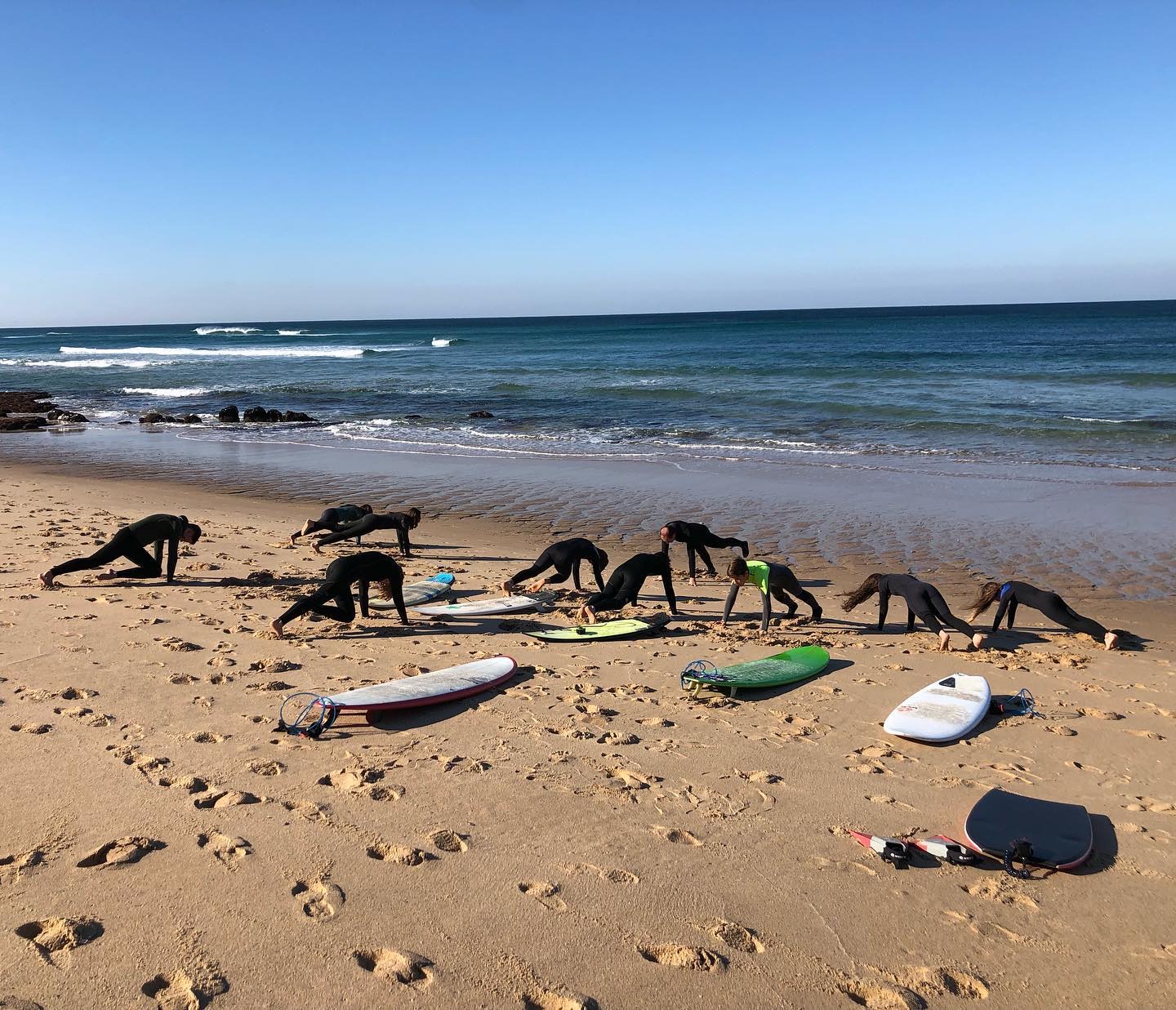 Surf class warming up on the beach